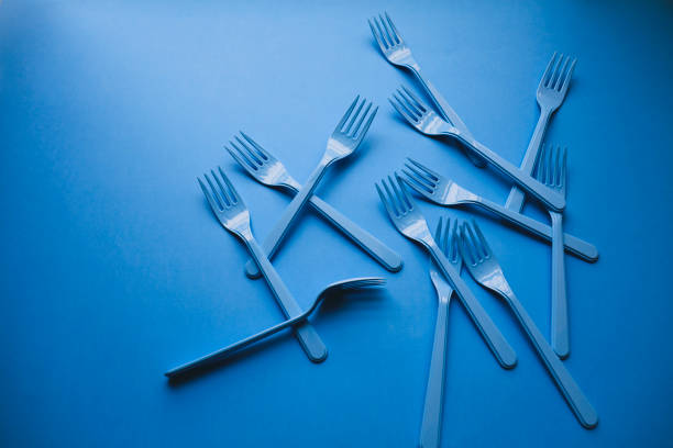 istock Close-up of forks on blue background 1081407632