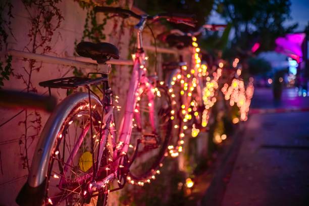 istock Pink bicycle with orange strip and blur light on the background 1081410322