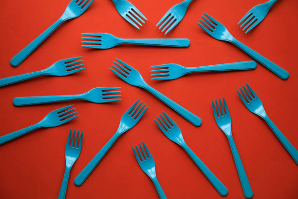 istock Close-up of blue forks on orange background 1081410718