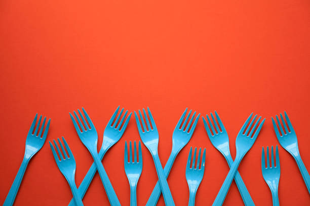 Close-up of blue forks on orange background