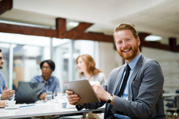 istock Young businessman using digital tablet and analyzing business report 1081410868