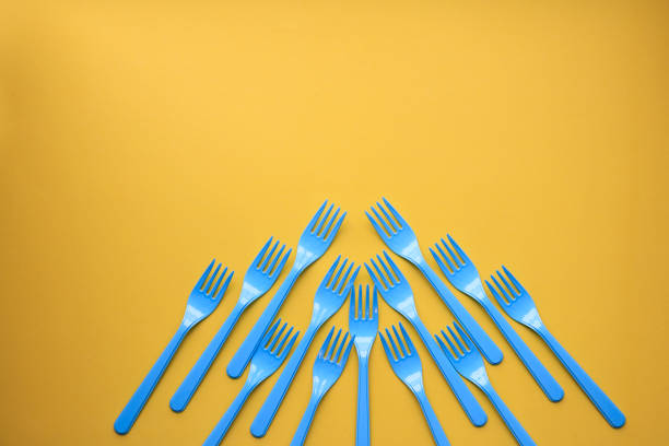 istock Close-up of blue forks on yellow background 1081411578