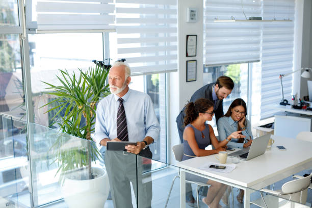 istock Senior businessman using digital tablet in the office 1081412378
