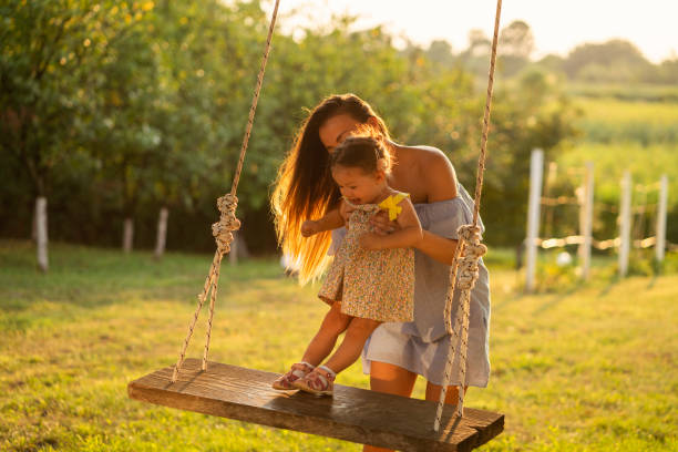 istock Mother and daughter enjoying on a swing 1081417244