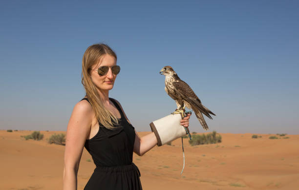 istock Woman with a falcon in a desert 1081427890