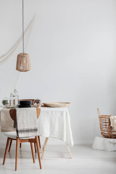 istock Copy space on empty white wall of bright elegant dining room with table with chairs 1081428032