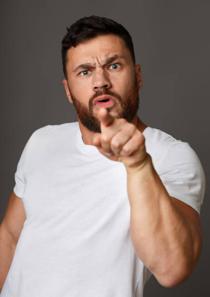 istock Angry man blaming you and pointing at camera 1081431422