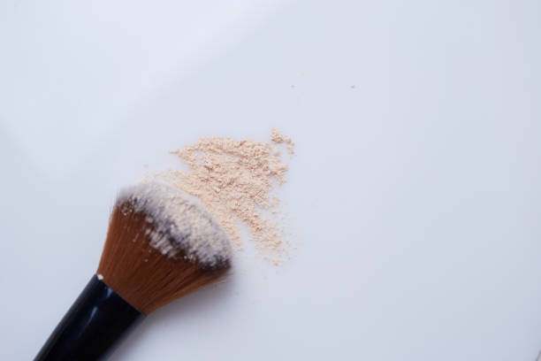 istock Cosmetics powder and brush on white background 1081436782