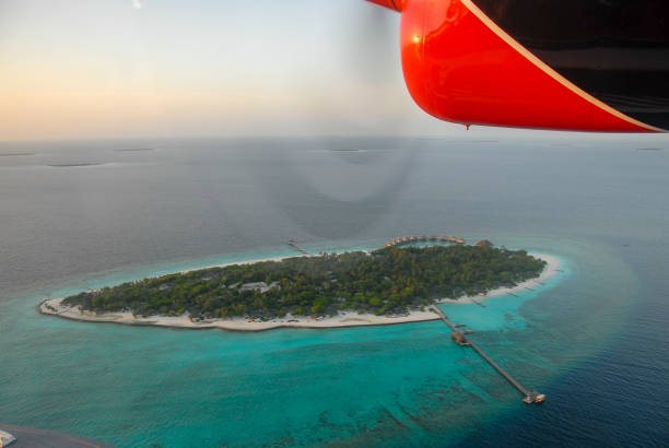 view of maldives seaplaned of the maldivian air taxi airline from male, aerial airborne view of islands and atolls within the maldives, indian ocean.  room for copy. - 3148 imagens e fotografias de stock