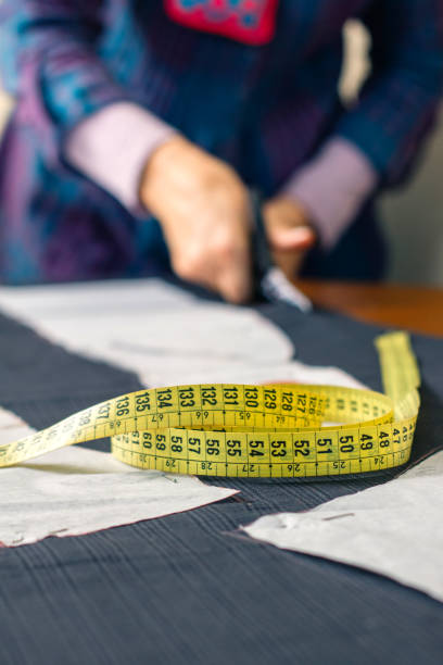 istock Measuring tape with dressmaker cutting in background 1081450392