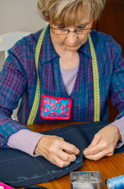istock Senior female seamstress sewing cloth 1081450866