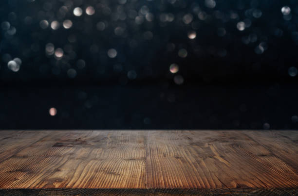 istock Dark bokeh background with wooden table 1081455124