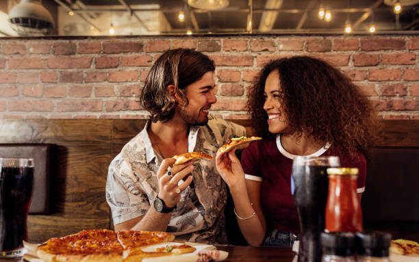 istock Couple enjoying eating pizza at cafe. 1081455192