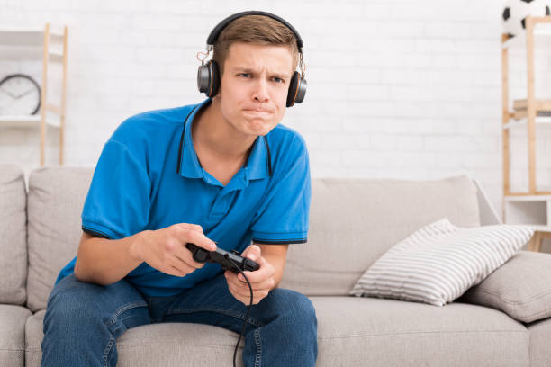 istock Teen boy playing on console with joystick 1081457186