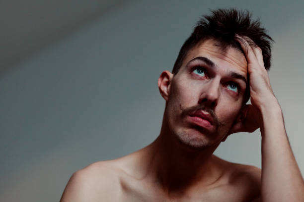 istock Young shirtless man with mustache thinking 1081458588