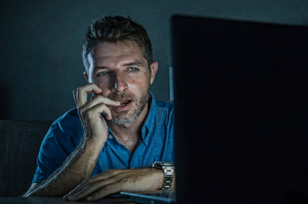 young aroused and excited sex addict man watching porn mobile online in laptop computer light night at home desk in pornography addiction and internet pornographic content concept young aroused and excited sex addict man watching porn mobile online in laptop computer light night at home desk in pornography addiction and internet pornographic content concept perv stock pictures, royalty-free photos & images