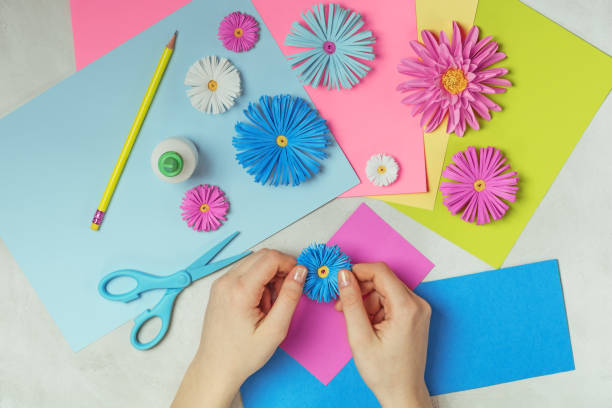 istock Female hands makes paper flower art. 1081476508