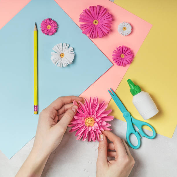 istock Female hands makes paper flower art. 1081476512