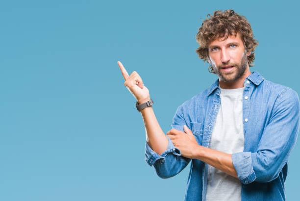 istock Handsome hispanic model man over isolated background with a big smile on face, pointing with hand and finger to the side looking at the camera. 1081477514