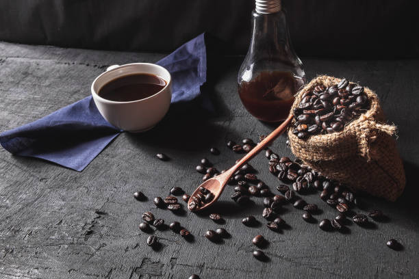 istock Hot coffee and raw coffee beans on black background 1081483446
