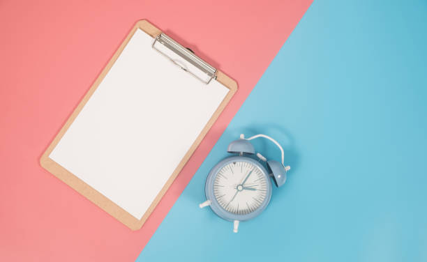 istock Clipboard and clock on colorful background with copy space. Flat lay modern and minimal style. 1081484562