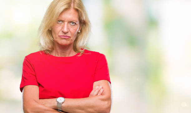 istock Middle age blonde woman over isolated background skeptic and nervous, disapproving expression on face with crossed arms. Negative person. 1081485830