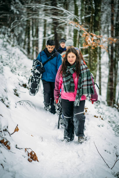 istock Friends snowshoe along snowy foot path 1081487930