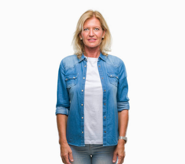 istock Middle age blonde woman over isolated background with serious expression on face. Simple and natural looking at the camera. 1081489894