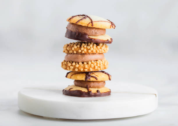 istock Luxury belgian chocolate and biscuit cookies selection on marble coasters and white kitchen table background. 1081492032