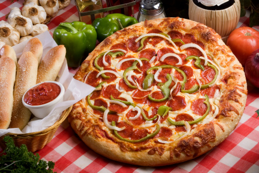 tasty juicy pizza on wooden background. lots of meat and cheese. Mushroom pizza. Pepperoni pizza. Mozzarella and tomato. Italian dish. Italian food
