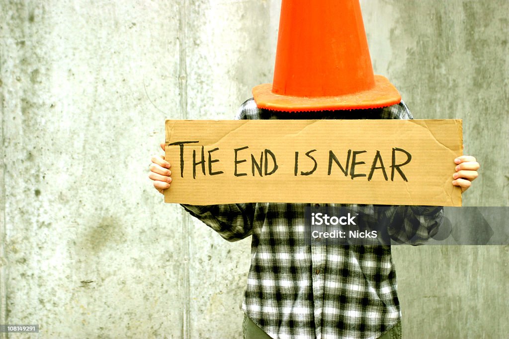 Person Holding The End is Near Sign  Humor Stock Photo