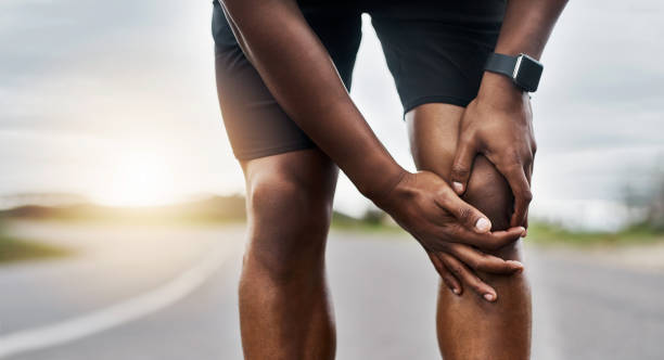 This doesn't feel right Closeup shot of a sporty man suffering with knee pain while exercising outdoors standing had to knee pose stock pictures, royalty-free photos & images