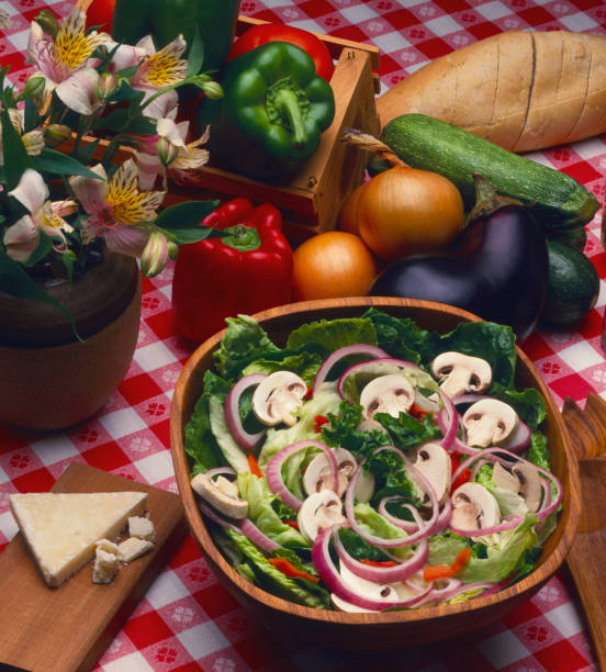 Salad Bowl and Vegetables on Checkered Table Cloth stock photo