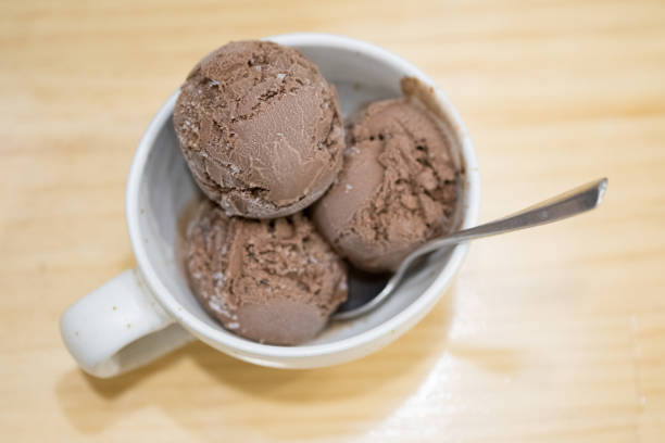 istock Chocolate ice cream in white bowl on wooden background 1081495134