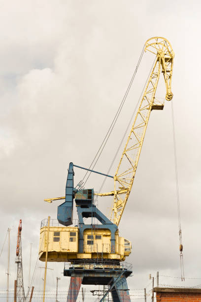 istock Old heavy harbor jib crane in seaport. 1081495148