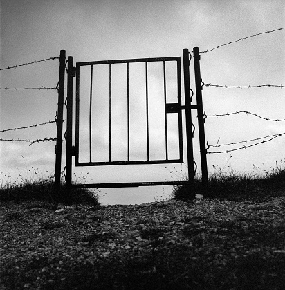 Closed gate into the sky.  (visible film noise)