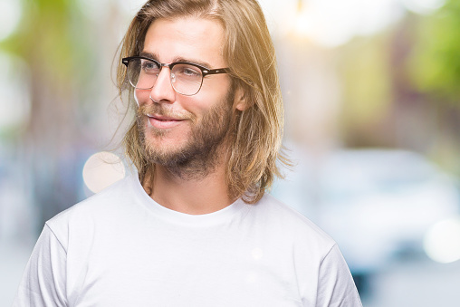 Young Handsome Man With Long Hair Wearing Glasses Over Isolated Background  Smiling Looking Side And Staring Away Thinking Stock Photo - Download Image  Now - iStock