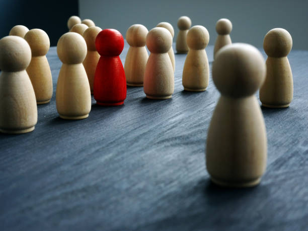 istock Be Unique, think differently, individuality. Wooden figures and one red figure. 1081498292