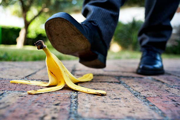 banana peel on the paved road stock photo