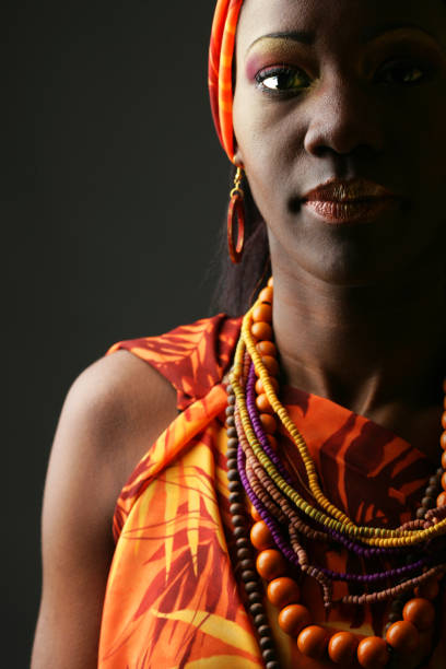 Young woman indicating direction to left or right in studio, pointing her index fingers aside. Confident natural person wears traditional ethnic clothes with floral native elements. Camera A.