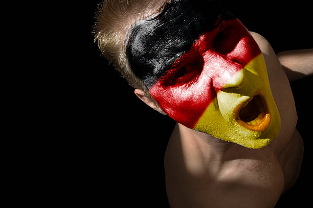 istock Man with German Flag Colors Painted Face, Isolated on Black 108150196