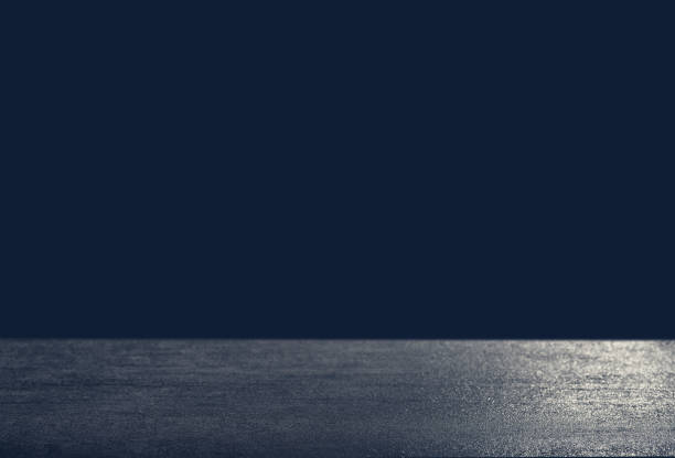 Dark background in front of empty stone concrete table for a celebration card, space for text modern look