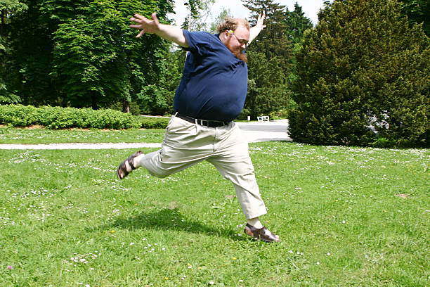 istock Happy and Overweight Man Jumping in the Grass 108150457
