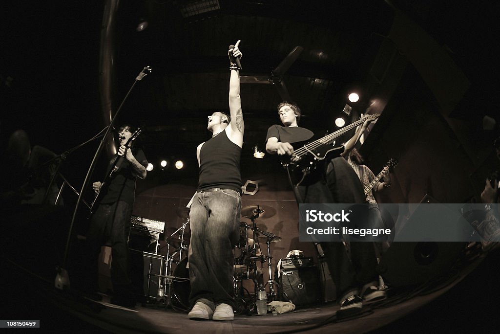 Band performing on stage, fisheye Band... NOTE there's a lot of noise, 800 ISO,and some motion. Istockalypse Slovenia 2006. http://www.lisegagne.com/images/casual.jpg Rock Group Stock Photo