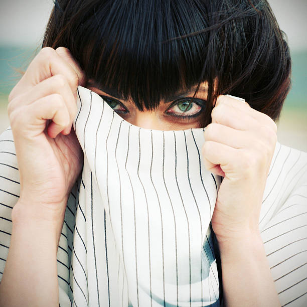 istock Young Woman Hiding in Shirt Collar 108150644