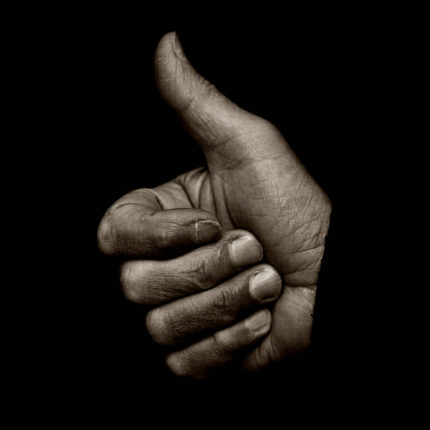 African American hand gripping a stone wall.