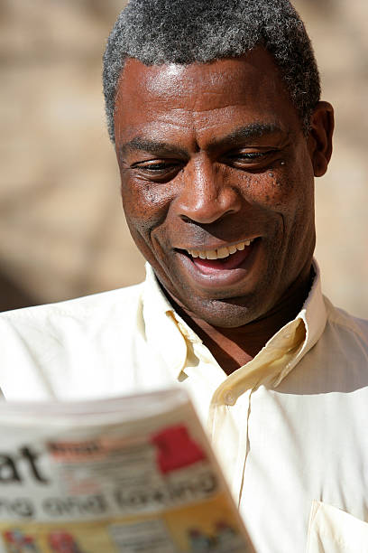 istock Mature Man Reading Newspaper and Smiling 108150847