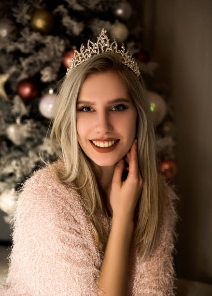 istock Young woman sitting beside Christmas tree 1081511518