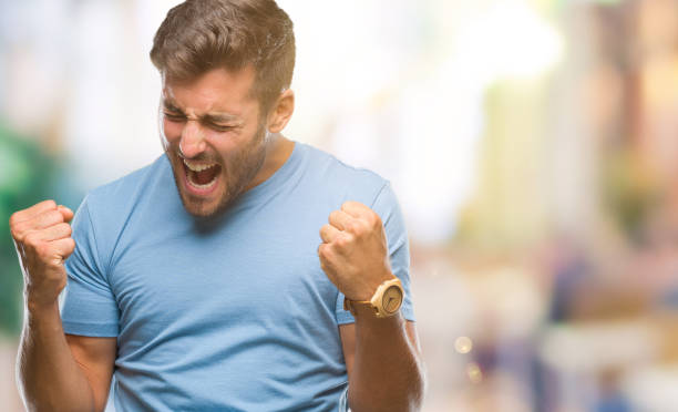 istock Young handsome man over isolated background very happy and excited doing winner gesture with arms raised, smiling and screaming for success. Celebration concept. 1081512062