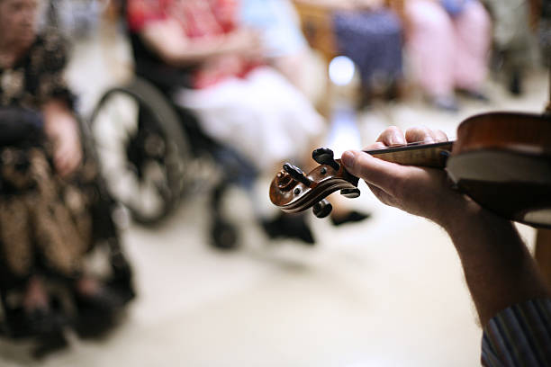Man Playing Violin in Nursing Home stock photo